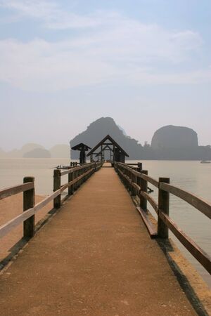 Long wooden mooring in lagoon in Thailandの写真素材