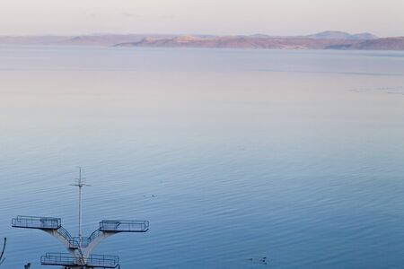 The morning quiet sea in rising sun beams