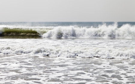 Sea surf on a sandy beach in the early springの写真素材