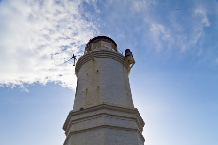 Lighthouse on the seashore in the solar morningの写真素材