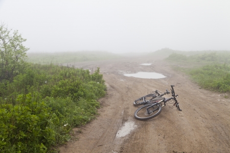 The bicycle on the prosyolochny road in the early foggy morningの写真素材