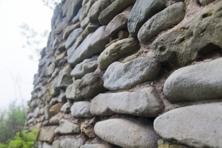 Ancient stone wall in an environment of greens and in a fogの写真素材
