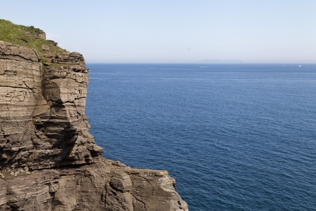 The sea and rocks under beams of a bright sunの写真素材