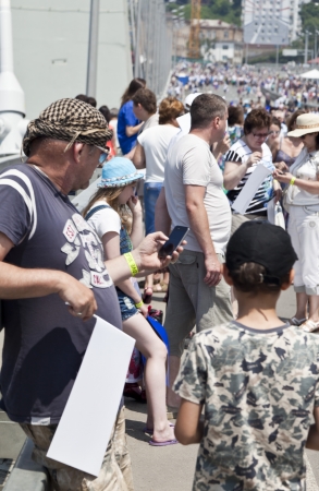 People celebrate city birthday, dance and walk on the bridge with children and tagsのeditorial素材