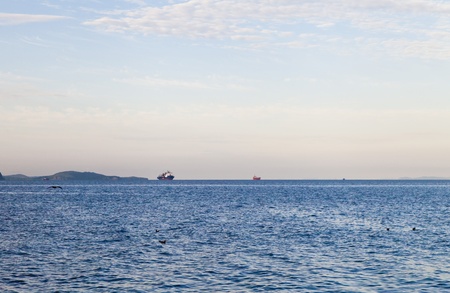 The warm sea under the bright blue sky in beams of a bright sunの写真素材