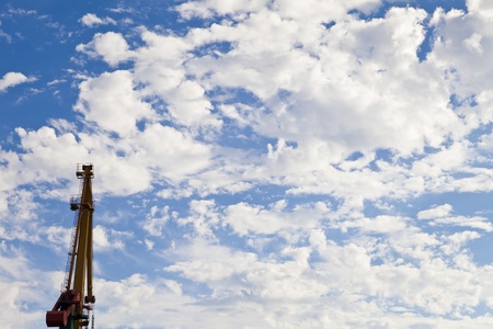 Cranes in port against the bright blue skyの写真素材