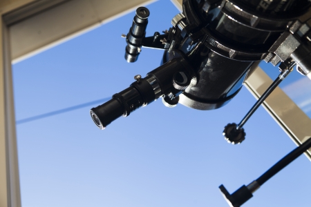 The telescope looks out of the window waiting for starsの写真素材