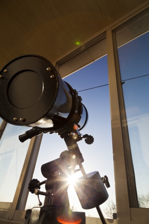 The telescope looks out of the window waiting for stars