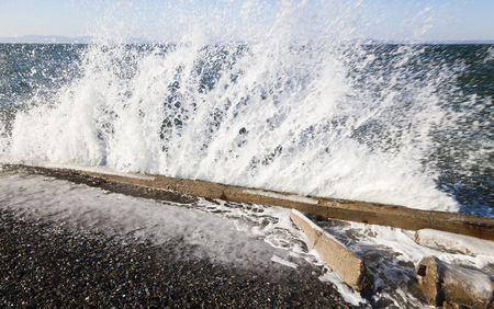 Sea surf at a strong wind on the city embankmentの写真素材