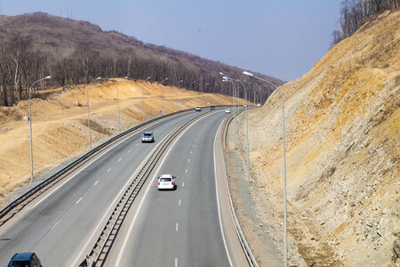 The road among mountains in the bright sunny day