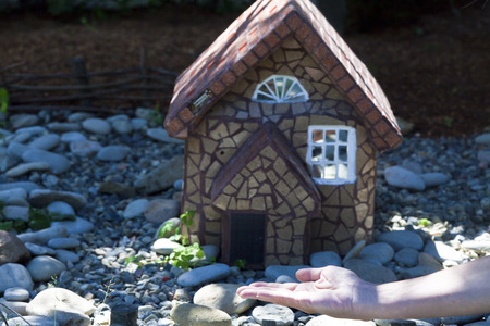 Small lodge on a small clearing under a bright sunの写真素材