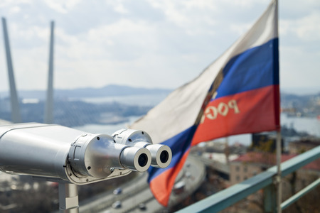 The tourist telescope looks at the sea and a big suspension bridgeの写真素材
