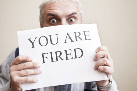 Inscription "You are fired" on the sheet of white paperの写真素材