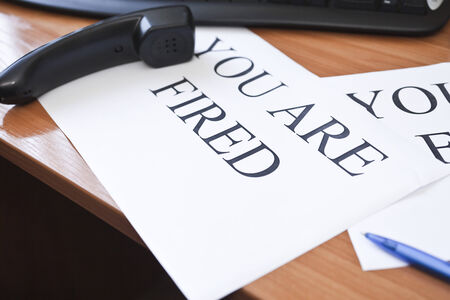 Inscription "You are fired" on the sheet of white paperの写真素材