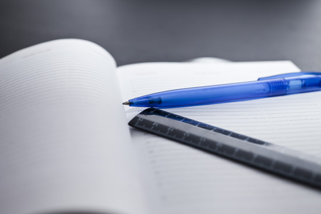 Table at office with papers, the calculator and a stationeryの写真素材