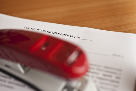 Table at office with papers, the calculator and a stationery