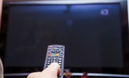 Remote control in a hand is going to change channels