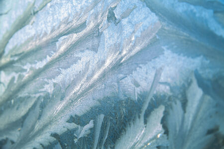 Ice at a window in clear frosty day in the cold winter