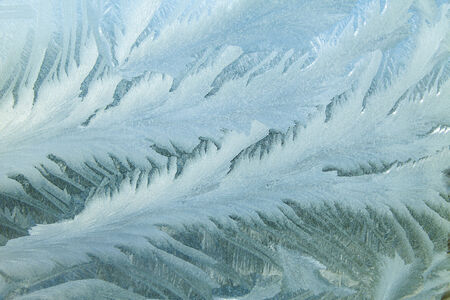 Ice at a window in clear frosty day in the cold winterの写真素材