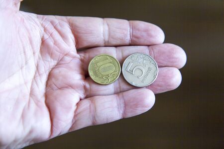 Coins in a hand lie as though last time