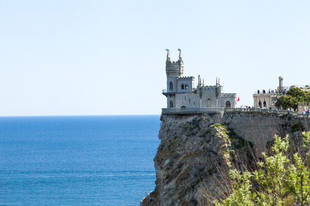 The castle by the sea is on the rock highly above waterの写真素材