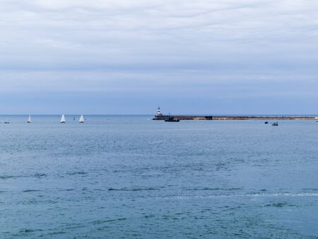 Sea bay in the city in cloudy weatherの写真素材