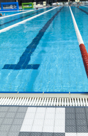The swimming pool under beams of the sun is ready to competitions and restの写真素材