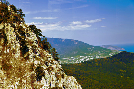 Mountains by the sea in beams of a bright sunの写真素材