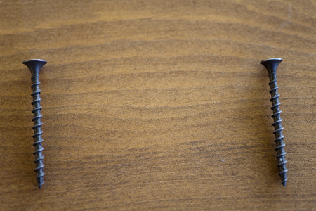 Screws on a table lie waiting for applicationの写真素材