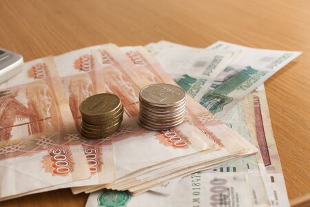 The roll of money on a table lies on pleasure to the owner