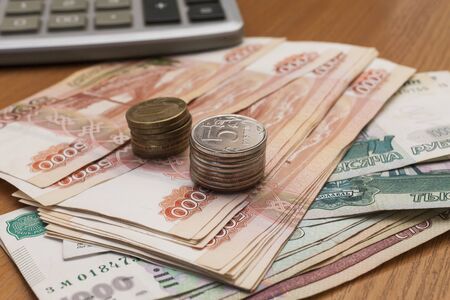 The roll of money on a table lies on pleasure to the ownerの写真素材