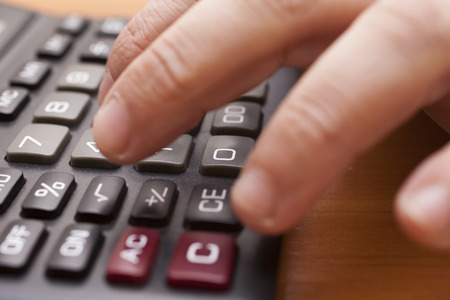 The calculator on a table is ready to calculationsの写真素材