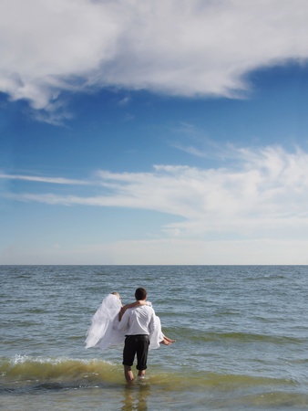 Couples going into the seaの写真素材