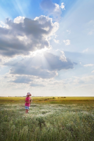 Girl in field with daisiesの写真素材