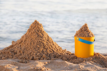 Bucket and the sand on the beachの写真素材