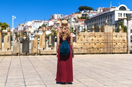 Young woman is walking on the beautiful old Lisbon street in Portugalの写真素材