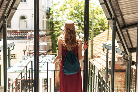 Young woman is walking on the beautiful old Lisbon street in Portugalの写真素材