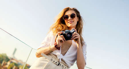 Young blonde tourist is exploring beautiful european city streetsの写真素材