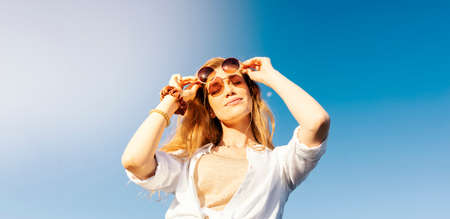 Young blonde tourist is exploring beautiful european city streetsの写真素材