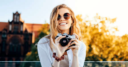 Young blonde tourist is exploring beautiful european city streets
