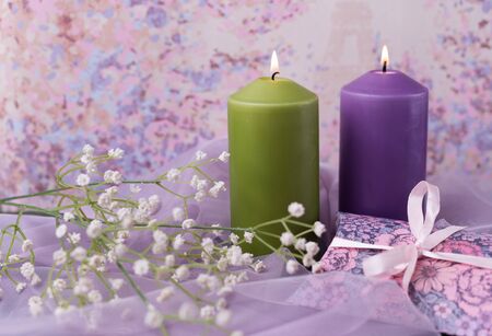 Valentine background or wedding. Candles, flowers, a gift in the form of a heart in purple tones.の写真素材