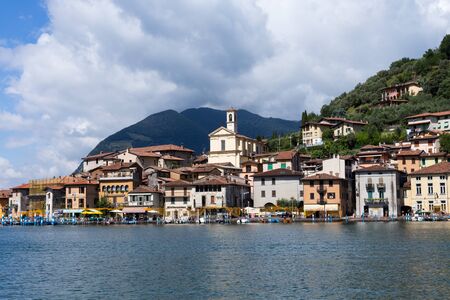 Monte Isola, Italy - June 29, 2017: View of the island from Lake Iseo, Lombardy with houses and mountains in the background.のeditorial素材