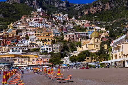 Positano, Amalfi Coast, Italy - April 9, 2017: beach with umbrellas on the background of the picturesque coast of the Amalfi Mediterranean Sea.のeditorial素材