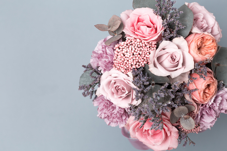 Closeup beautiful flowers in pastel colors on a blue background. Greeting card, Moms day, wedding invitation, birthday .Copy space. Vintage, retro photo processingの写真素材