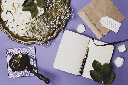 Autumn composition with petals of white roses on a vintage tray and an empty diary on a blue table, Coffee Turk . Flat layout, place for textの写真素材