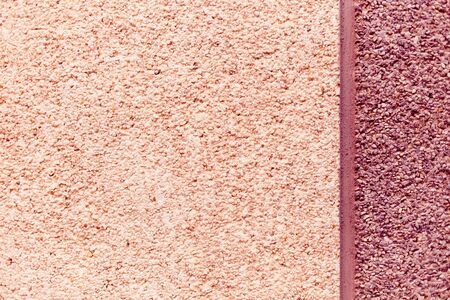 Stone wall, smooth surface, asphalt crumb, bitumen background. The decoration is done in pink tones, separated by a cement vertical stripの写真素材
