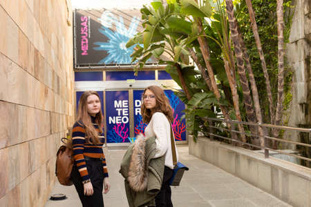 Valencia, Spain - January 02, 2020: stylish urban portrait of two fashionable girls walking in the...