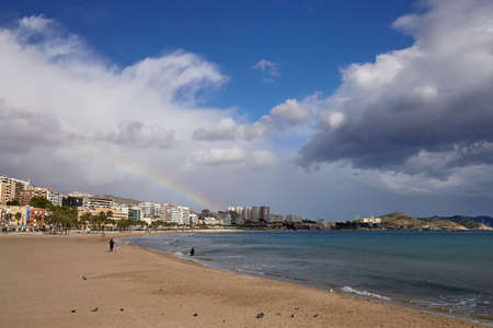 Rainbow over the old town of Villajoyosa with colorful houses, mountains and the sea, Spain.の写真素材
