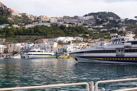 Capri island, Italy - April 12, 2017: Panorama of the seaport Marina Grande, view from the water on ships and colorful houses on the coastのeditorial素材
