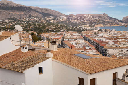 View of the tiled roofs of the village of Altea, overlooking the sea and the mountain range,...